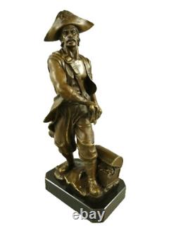 Antique bronze pirate figurine on a black marble