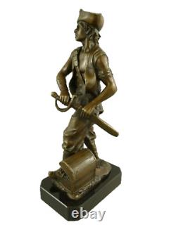 Antique bronze pirate figurine on a black marble