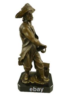 Antique bronze pirate figurine on a black marble