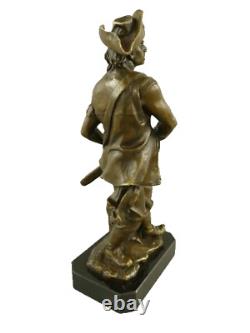 Antique bronze pirate figurine on a black marble