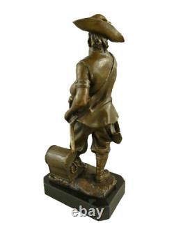 Antique bronze pirate figurine on a black marble