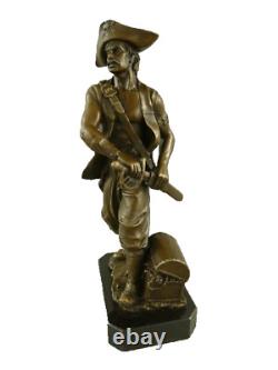 Antique bronze pirate figurine on a black marble