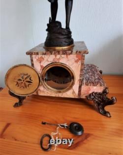 Art Nouveau Mantel Clock, patinated spelter figure with bronze finish on pink marble, signed