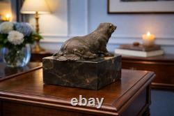 Bronze bear sculpture on a black marble base after Milo