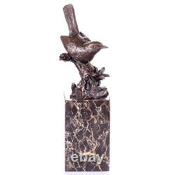 Bronze bird figurine on marble