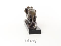 Bronze cougar statue by the pool on a black marble base, signed
