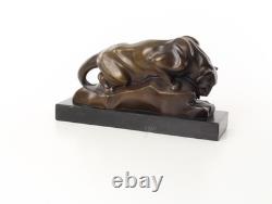 Bronze cougar statue by the pool on a black marble base, signed