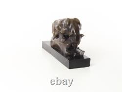 Bronze cougar statue by the pool on a black marble base, signed