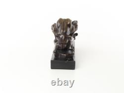 Bronze cougar statue by the pool on a black marble base, signed