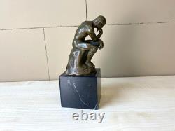 Bronze sculpture The Thinker on black marble after Auguste Rodin