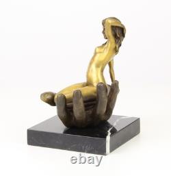 Bronze sculpture of a hand holding a woman on a marble base after Juno