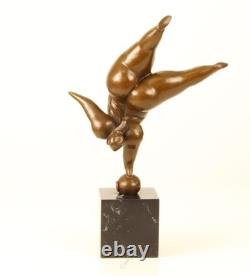 Bronze sculpture of a lady balancing on a black marble base after Milo