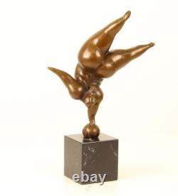 Bronze sculpture of a lady balancing on a black marble base after Milo