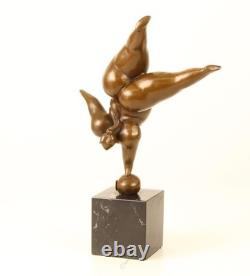 Bronze sculpture of a lady balancing on a black marble base after Milo Bronze sculpture of a lady balancing on a black marble base after Milo