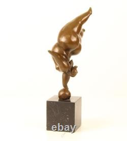 Bronze sculpture of a lady balancing on a black marble base after Milo