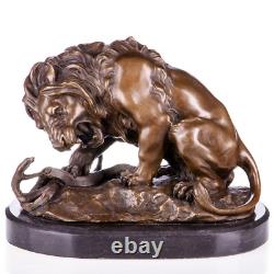 Bronze sculpture of a lion with a serpent on a marble base after Barye