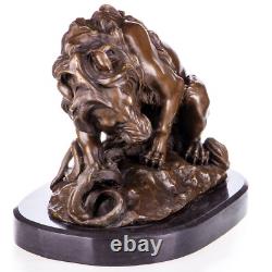 Bronze sculpture of a lion with a serpent on a marble base after Barye