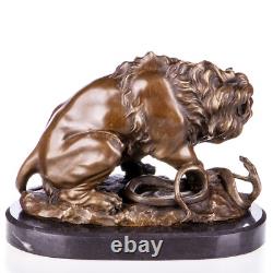 Bronze sculpture of a lion with a serpent on a marble base after Barye