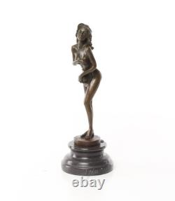 Bronze sculpture of a nude woman on a black marble pedestal Signed