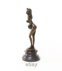 Bronze sculpture of a nude woman on a black marble pedestal Signed