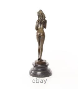Bronze sculpture of a nude woman on a black marble pedestal Signed