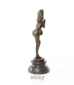 Bronze sculpture of a nude woman on a black marble pedestal Signed