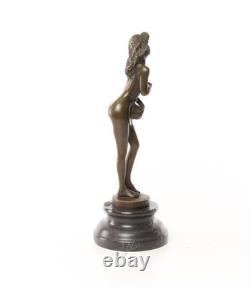 Bronze sculpture of a nude woman on a black marble pedestal Signed