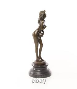 Bronze sculpture of a nude woman on a black marble pedestal Signed