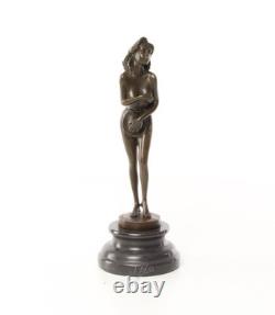 Bronze sculpture of a nude woman on a black marble pedestal Signed