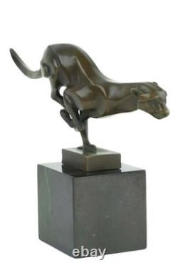 Bronze sculpture of a running cheetah on a black marble base, signed