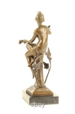 Bronze sculpture of a seated lady with a bird on a black marble base after Nick