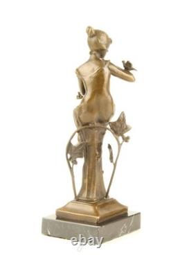 Bronze sculpture of a seated lady with a bird on a black marble base after Nick