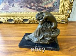 Bronze sculpture of a seated woman on a black marble base after Milo