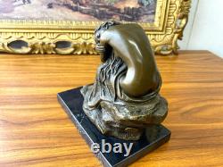 Bronze sculpture of a seated woman on a black marble base after Milo