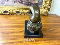 Bronze sculpture of a seated woman on a black marble base after Milo