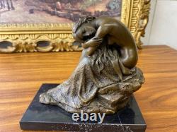 Bronze sculpture of a seated woman on a black marble base after Milo