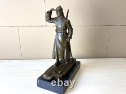 Bronze sculpture of a soldier on skis on a black marble base signed