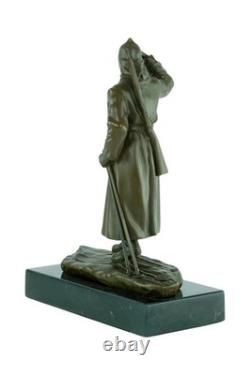 Bronze sculpture of a soldier on skis on a black marble base signed
