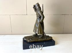 Bronze sculpture of a soldier on skis on a black marble base signed
