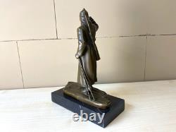 Bronze sculpture of a soldier on skis on a black marble base signed