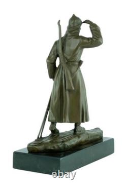 Bronze sculpture of a soldier on skis on a black marble base signed