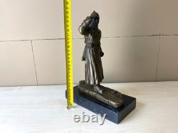 Bronze sculpture of a soldier on skis on a black marble base signed