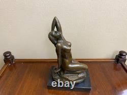 Bronze sculpture of a woman on a black marble base after Jean Patoue