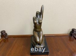 Bronze sculpture of a woman on a black marble base after Jean Patoue