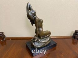 Bronze sculpture of a woman on a black marble base after Jean Patoue