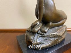 Bronze sculpture of a woman on a black marble base after Jean Patoue