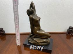 Bronze sculpture of a woman on a black marble base after Jean Patoue