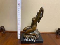 Bronze sculpture of a woman on a black marble base after Jean Patoue