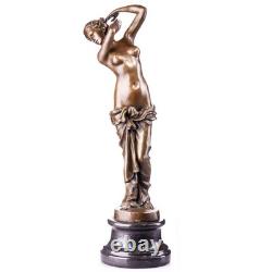 Bronze sculpture of a woman on a black marble base, after, signed