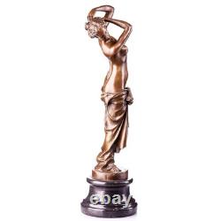 Bronze sculpture of a woman on a black marble base, after, signed